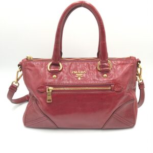 Prada Stylish red leather handbag with gold accents